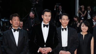 Japanese sportsman Hitoki Iwase, South Korean actors Jung Woo-sung and Lee Jeong-jae, and a guest attend the screening of 'Hunt'. Getty