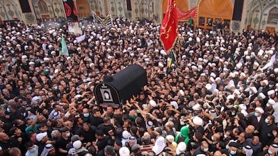 Iraqis carry the coffin of Mohammed Saeed Al Hakim during his funeral in Najaf. AFP