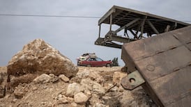 A vehicle heads south past a bridge damaged in an Israeli strike in Qasmiyeh, Lebanon. Reuters