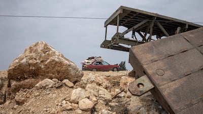 A vehicle heads south past a bridge damaged in an Israeli strike in Qasmiyeh, Lebanon. Reuters