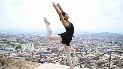 Ballet student Nicole Chavez (15) performs at the San Genaro neighborhood in the Chorrillos district, south of Lima, on April 1, 2023. - At an arid and dry hill in Lima, a group of girls wearing leotards stand on their toes in a rocky and dusty road. Hardly any of them will become a professional dancer, acknowledges without bitterness Maria del Carmen Silva, instructor of the ballet that finances itself from recycling in Peru. (Photo by Ernesto BENAVIDES / AFP)