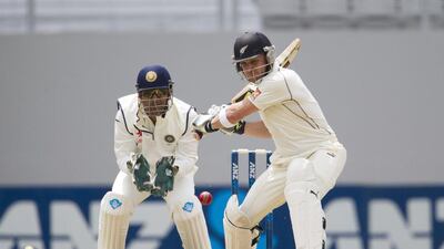 Captain and wicketkeeper MS Dhoni, left, watches Captain Brendon McCullum of New Zealand bat during day one of the international cricket match Test match between New Zealand and India at Eden Park in Auckland on Wednesday. AFP PHOTO / David Rowland