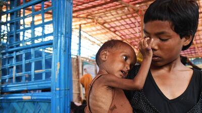 Rohingya refugees wait to see a doctor at the Balukhali refugee camp in Bangladesh's Ukhia district, AFP/Dibyangshu Sarkar