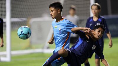 A Minerva Academy player, left, shields the ball from a La Liga HPC player during the U12 Mina Cup final.