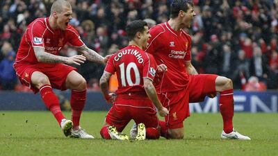 Philippe Coutinho, centre, celebrates his winning goal with Martin Skrtel, left, and Dejan Lovren, right. Phil Noble / Reuters