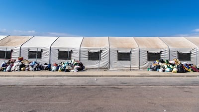 Migrants' belongings piled on the ground outside the new Los Rosales migrant reception camp. AFP