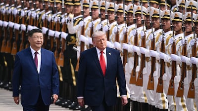 US President Donald Trump, right, and China's President Xi Jinping inspect a guard of honour during a welcome ceremony at the Great Hall of the People in Beijing. AFP
