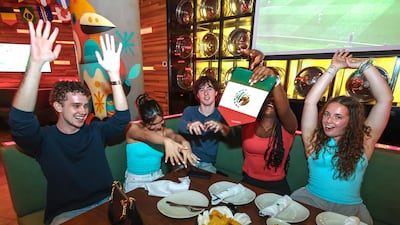 Football fans gather at Loca Restaurant and Bar in Abu Dhabi for the opening fixture of the tournament. Victor Besa / The National