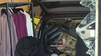 People look at the car that crashed into a shop in the Greenacre suburb of Sydney, Australia. REUTERS