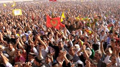 Men wave a flag of the banned Kurdish group, the PKK.