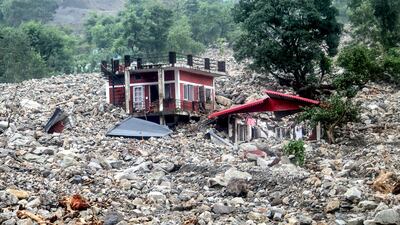 A residential building is pounded by rocks after a cloudburst following heavy rain in the Sahastradhara region of Dehradun in India's Uttarakhand state. AFP