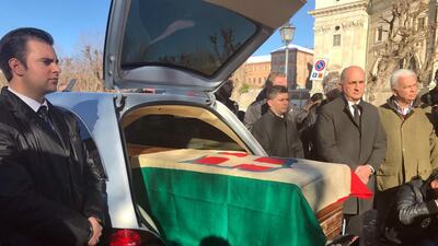 The coffin with the remains of Italy's King Victor Emmanuel III, draped in a flag with the House of Savoy crest, arrives in Vicoforte, Italy, after being repatriated from Egypt and interred in a family mausoleum. (Raffaele Sasso/ANSA via AP)