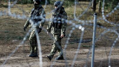 Polish police officers patrol the border. Reuters