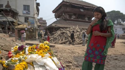 A Nepalese woman pays her tribute to the April 25 earthquake victims at Bashantapur Durbar Square, a Unesco world heritage site, in Kathmandu, Nepal on May 7, 2015. Athit Perawongmetha/Reuters