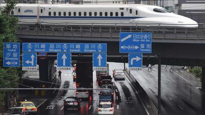A Shinkansen bullet train moves on tracks above traffic in Tokyo on August 14, 2017. Japan's economy has notched its longest economic expansion in over a decade. Kazuhiro Nogi / AFP