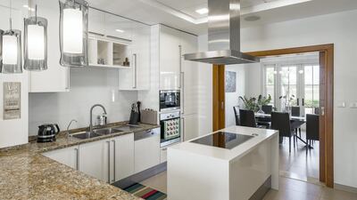 The kitchen includes the sought-after island. Courtesy LuxuryProperty.com