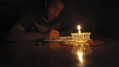 Mostafa Khaled, 20, studies by candlelight for his early morning exams during a power cut in Toukh, El Kalubia governorate, about 25-kilometres northeast of Cairo on May 26, 2013. Amr Abdallah Dalsh / Reuters