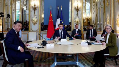 Mr Xi, Mr Macron and Ms von der Leyen at their meeting on Monday. AP