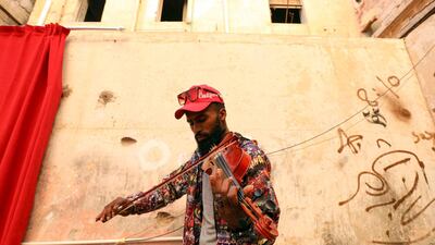 A musician plays the violin during a rare cultural event in the eastern city of Benghazi. The week's events started with an exhibition by artist Elham el-Ferjani from Tripoli, on the other side of the country's bitter east-west divide. AFP