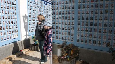 Residents in Kyiv view a memorial wall to Ukrainian soldiers who died in the continuing war with Russia. AFP