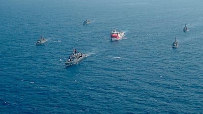 Turkey's research vessel, 'Oruc Reis', centre, is surrounded by Turkish navy vessels as it was heading in the west of Antalya on the Mediterranean AP