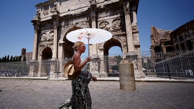 Mathilde from France shelters from the sun near the Colosseum in Rome. Reuters
