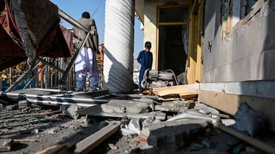 People inspect a damaged house after several rockets land at Khair Khana, north west of Kabul. A series of loud explosions shook central Kabul, including several rockets that landed near the heavily fortified Green Zone where many embassies and international firms are based, officials said. /AFP