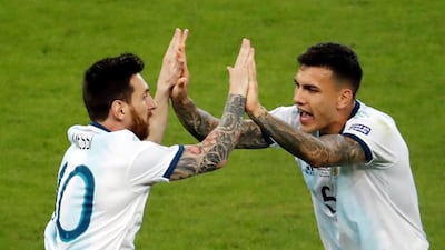 Argentina's Lionel Messi, left, reacts after scoring against Paraguay. EPA