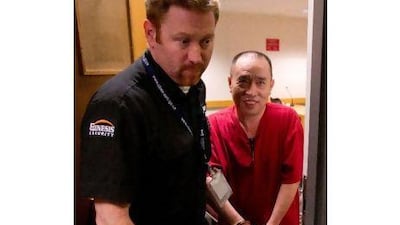 Lai Changxing, right, is escorted by a security guard from an Immigration and Refugee Board detention hearing in Vancouver, British Columbia.
