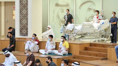 Long-term patients and their family take part in the special Eid prayers in the atrium.