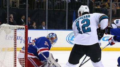 Antti Raanta of the New York Rangers makes a first period save on Patrick Marleau of the San Jose Sharks in their NHL contest on Monday night. Bruce Bennett / Getty Images / AFP / October 19, 2015