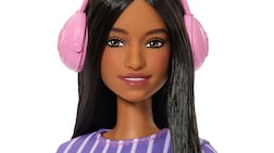 The new doll wears noise-cancelling headphones. Mattel / PA Wire