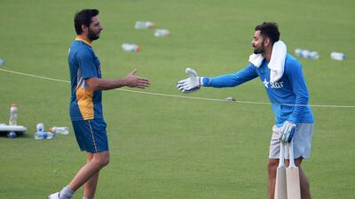 Shahid Afridi, left, and Virat Kohli meet during training at the Eden Gardens in Kolkata ahead of their match at the 2016 T20 World Cup. AFP