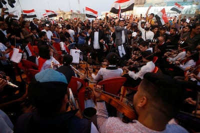 An Iraqi orchestra plays the national anthem as the demonstrators gather in front of Basra provincial building during protests in southern Iraq. Reuters