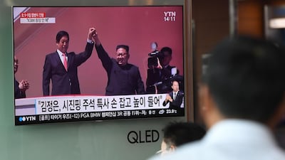 People watch a television news reporting a parade marking the 70th anniversary of the foundation of North Korea held in Pyongyang. AFP