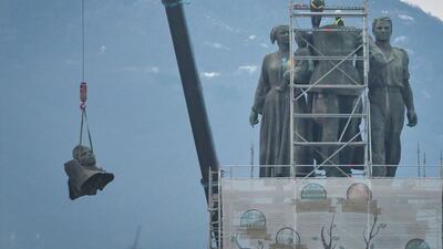 Workers remove a head from the Soviet Army monument depicting a Soviet soldier, a worker and a mother and her child, in Sofia, Bulgaria. Work to dismantle the monument began this week after years of controversy between Russophiles and pro-Europeans in the former Communist country. AFP