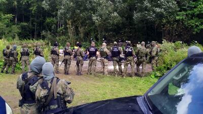 Migrants are faced with patrol guards after crossing the border from Belarus into Poland near the village of Usnarz Gorny. AP