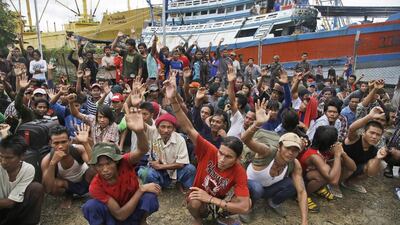 Myanmar fishermen raise their hands as they are asked who among them want to go home at the compound of Pusaka Benjina Resources fishing company in Benjina, Indonesia on April 3, 2015. Dita Alangkara/AP Photo