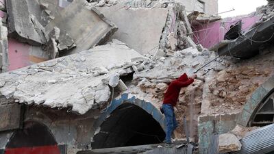 A youth stands at the site of a regime air strike in Ariha town in Syria's last major opposition bastion of Idlib. AFP