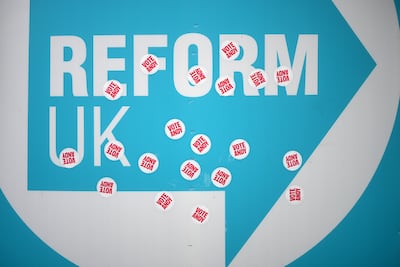 'Vote Andy' stickers are stuck on a Reform UK placard in Makerfield. Getty