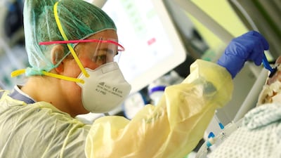 A nurse shaves a patient suffering from Covid-19 at the Intensive Care Unit of the "Klinikum Darmstadt" clinic in Darmstadt, Germany. Reuters