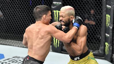 Joseph Benavidez, left, and Deiveson Figueiredo trade blows. Getty Images