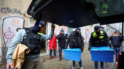 German police officers carry evidence collected during raids. Reuters