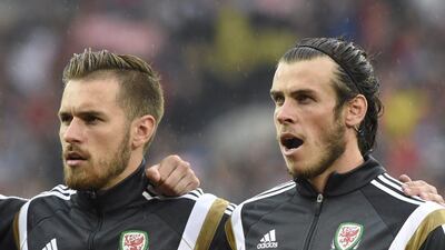 Wales players Aaron Ramsey and Gareth Bale sing the national anthem before their Euro 2016 qualifying match on Friday night against Belgium. Rebecca Naden / Reuters