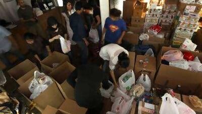 Volunteers prepare boxes of donations for flood victims in Pakistan at The Shelter in Al Qouz.
