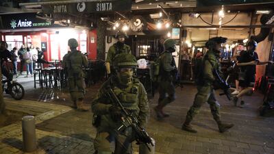 Police closed roads and ordered public transport to be shut down during the search for the man, who was later found hiding near a mosque in Jaffa. EPA