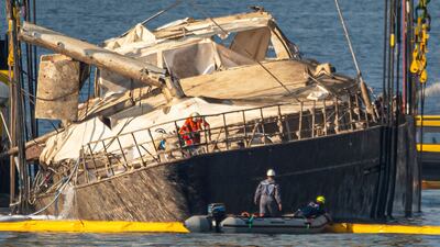 The hull of the superyacht Bayesian, which sank near Palermo, Sicily, in 2024, is lifted by cranes during salvage operations off the village of Porticello. AP