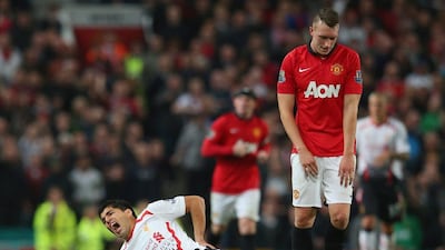 Luis Suarez, in white, is not the most popular football players in the Premier League. Julian Finney / Getty Images