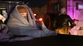 Members of the Kurdish-led Syrian Democratic Forces wrap up warm as they head towards Kobani after withdrawing from the outskirts of Raqqa city. AFP