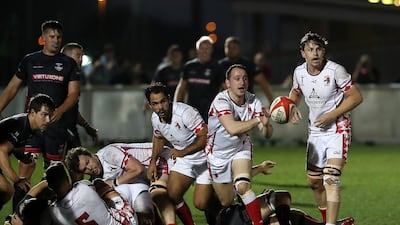 Abu Dhabi Harlequins pass the ball against Dubai Exiles.